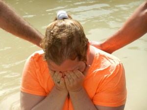 Praying before being baptized in the Jordan.